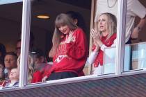 Taylor Swift waves from a suite alongside Brittany Mahomes, right, during the first half of an ...