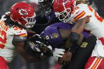 Kansas City Chiefs safety Justin Reid (20) and Chiefs linebacker Nick Bolton (32) sack Baltimor ...
