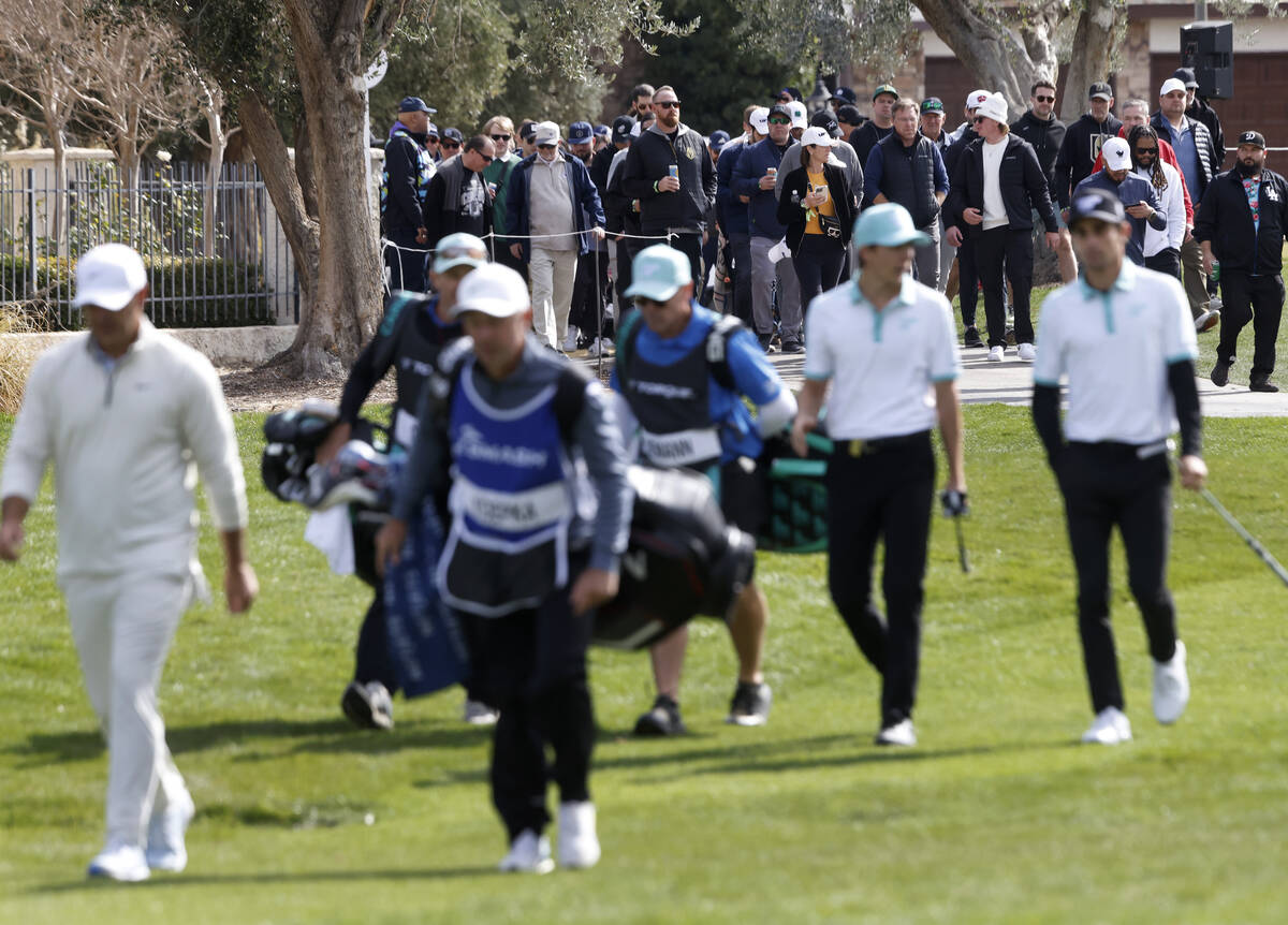 Fans follow players during the second round of LIV Golf Las Vegas tournament at Las Vegas Count ...