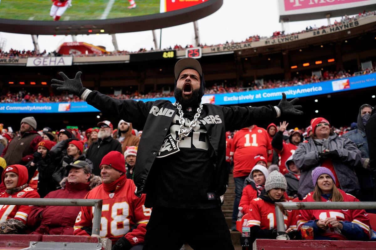 A Las Vegas Raiders fan celebrates a score by his team during the first half of an NFL football ...