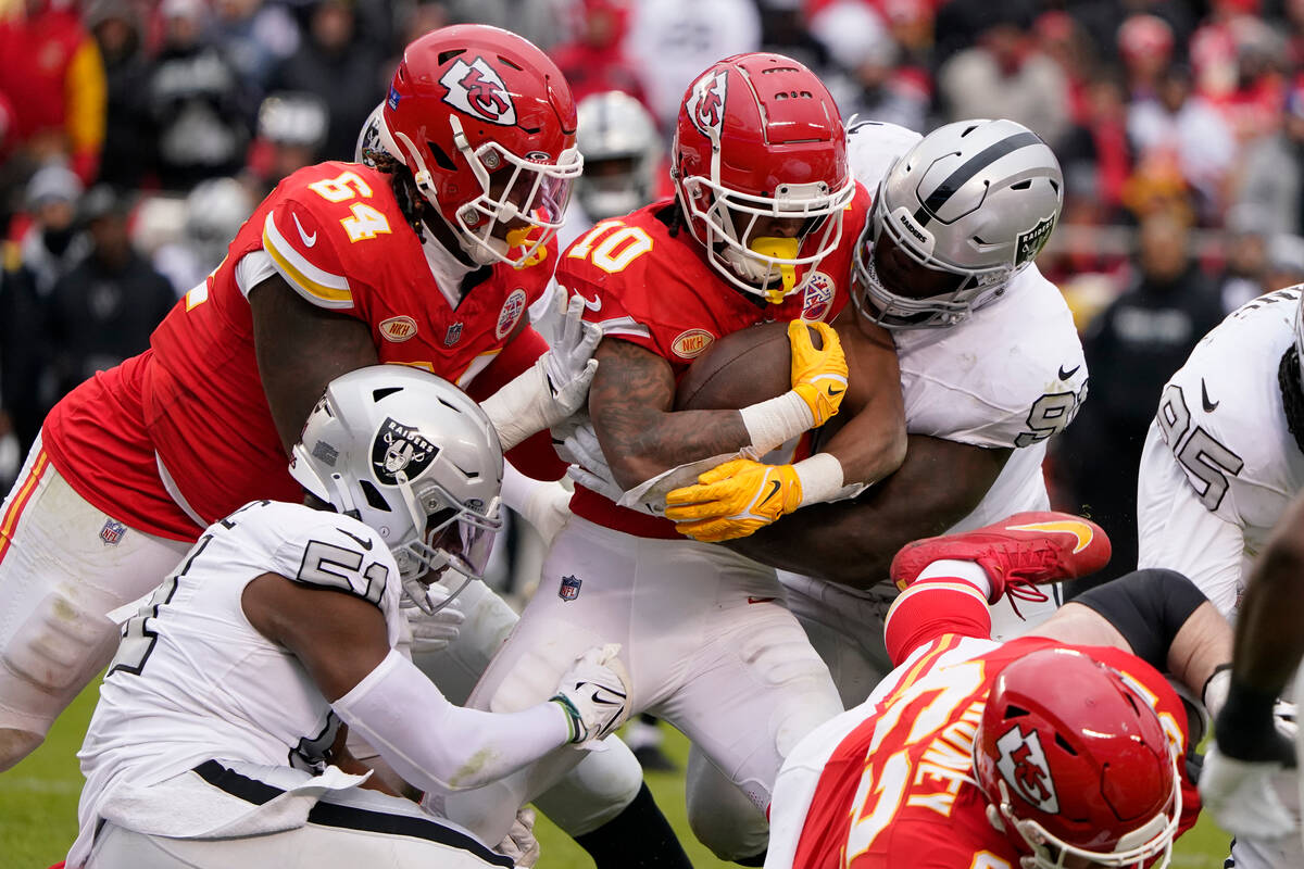 Kansas City Chiefs running back Isiah Pacheco (10) is stopped by Las Vegas Raiders defensive en ...
