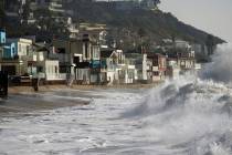 FILE - Waves break near beach homes in Malibu, Calif., on Dec. 28, 2023. An earthquake with a p ...