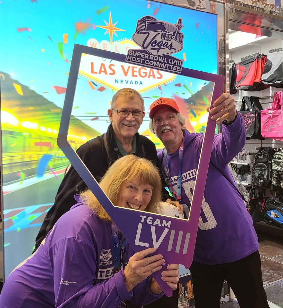 Super Bowl Host Committee volunteers Cheryl Anderson and Stephen Harenza get their picture take ...