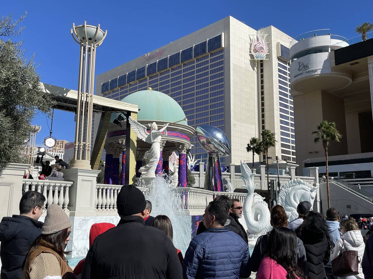 A line of people waiting to get their picture taken at a photo backdrop near Caesars Palace on ...