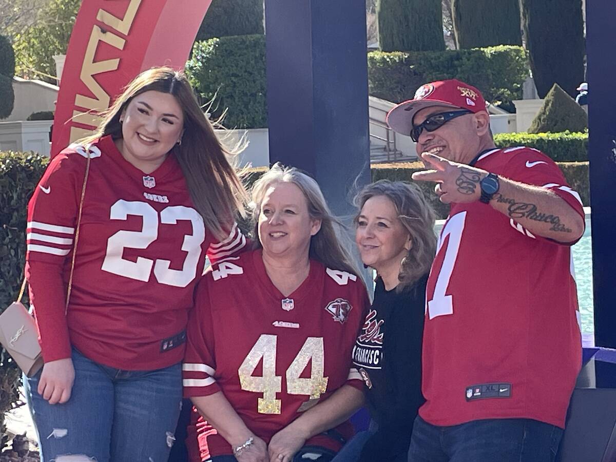 Samantha Gomez (left) poses in front of the Super Bowl photo backdrop near Caesars Palace on Sa ...