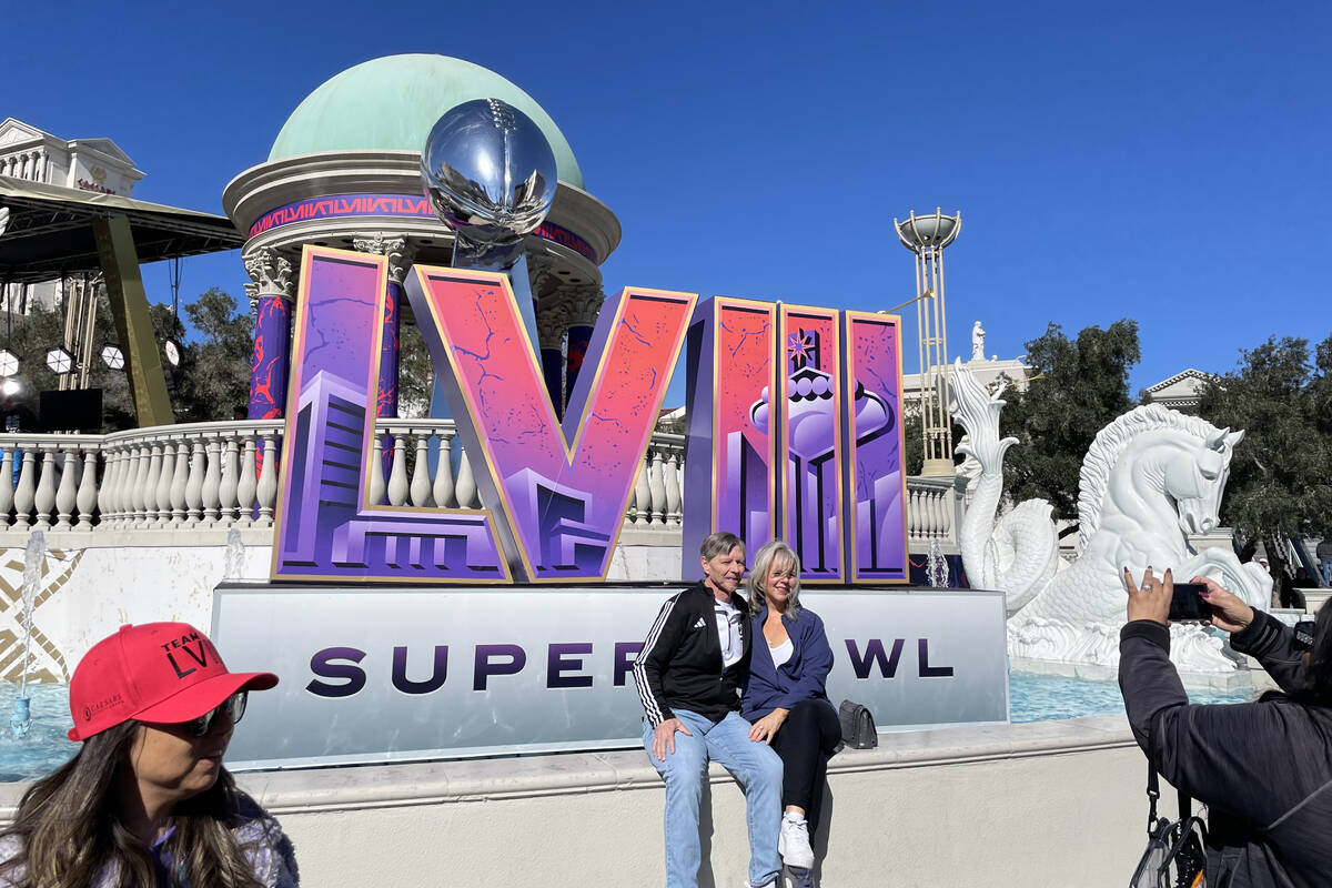 A couple poses at a photo backdrop near Caesars Palace on Saturday, Feb. 10, 2024. (Julie Woott ...