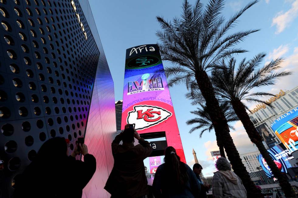 Football fans photograph a Super Bowl marquee at Aria, Saturday, Feb. 10, 2024, on the Las Veg ...