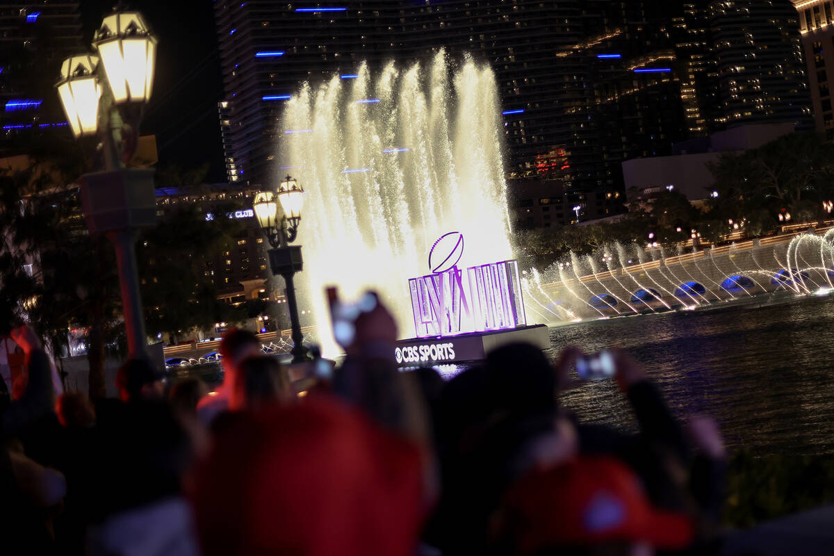 People record the Bellagio Fountains Saturday, Feb. 10, 2024, on the Las Vegas Strip. The NFL S ...