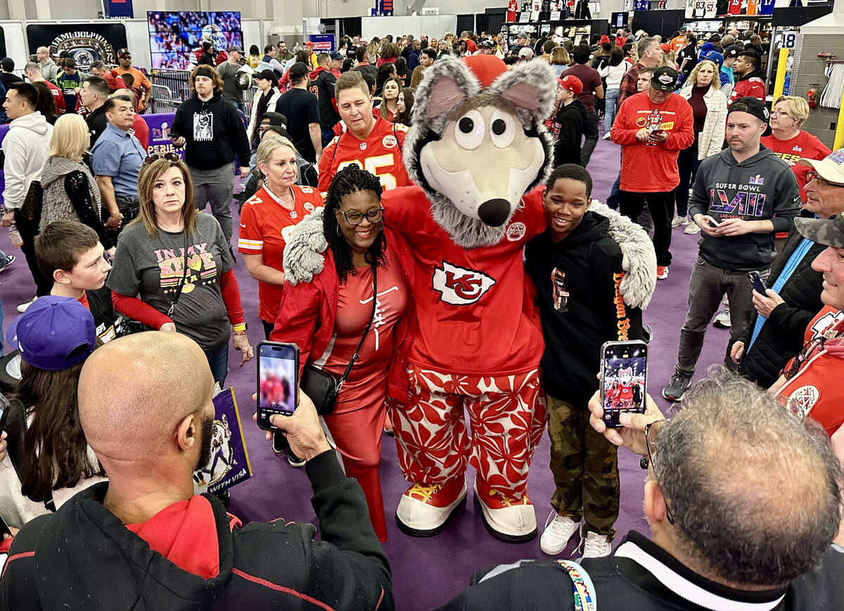 The Kansas City Chiefs' mascot, K.C. Wolf, poses with Chiefs fans at the Super Bowl Experience ...
