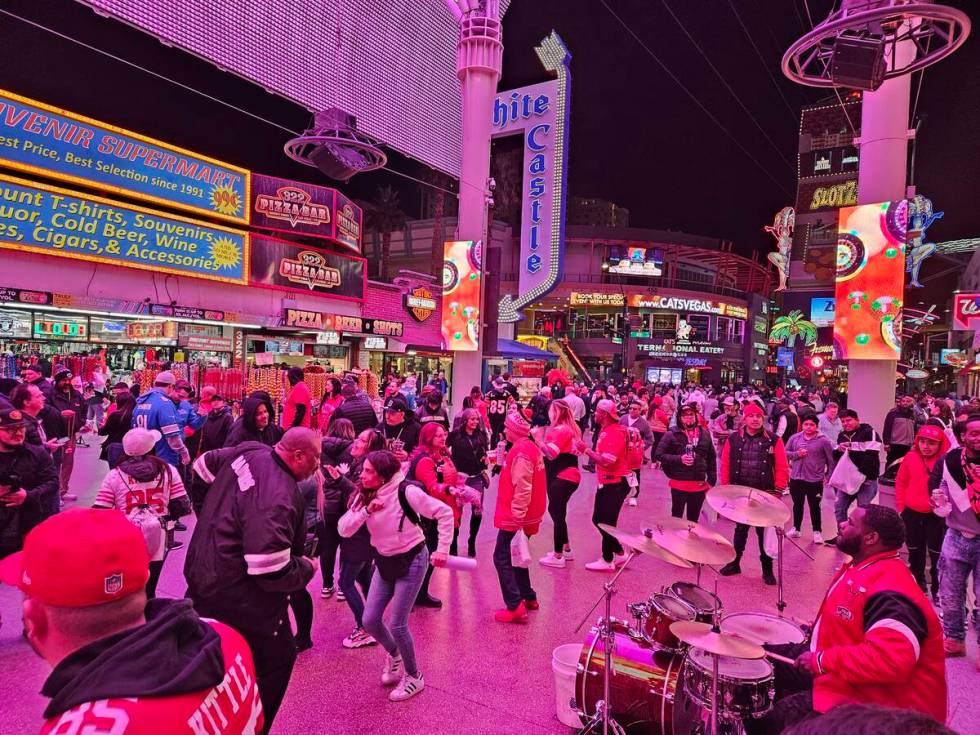 Fans dance it off on the Fremont Street Experience after the Chiefs beat the 49ers in Super Bow ...