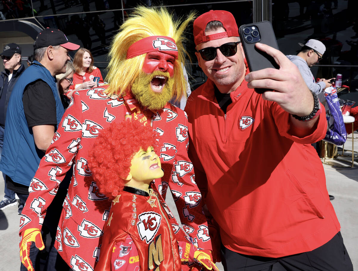 A Chiefs fan, poses with Rick Draper and his son Hoyt Draper, 8, outside Allegiant Stadium in L ...