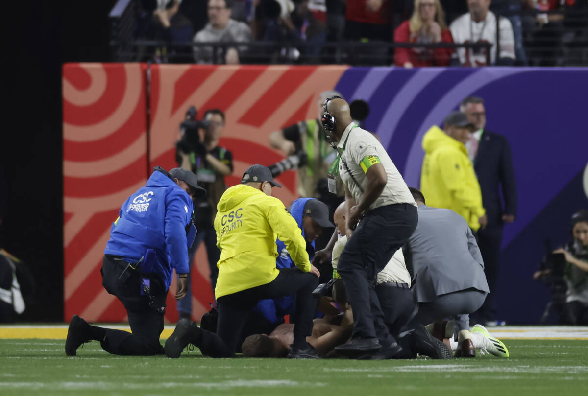 A man who ran onto the field is stopped by security during the second half of Super Bowl 58 bet ...