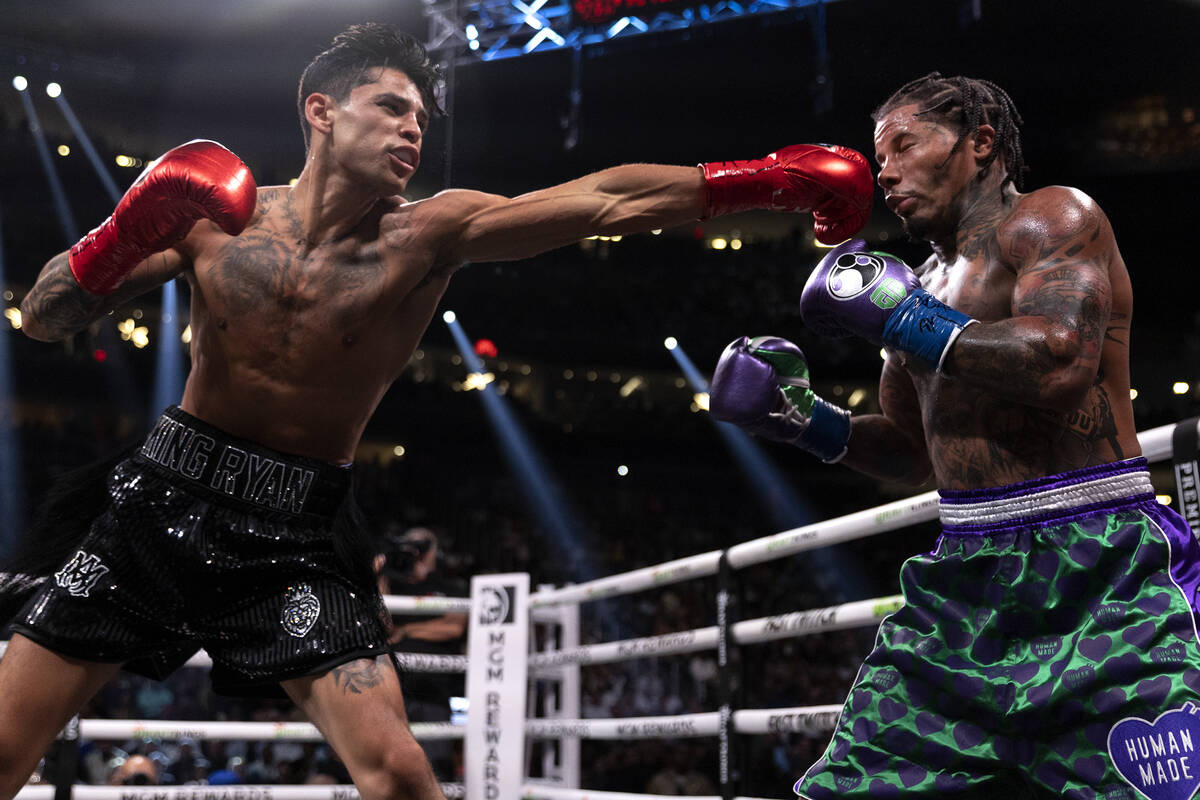Ryan Garcia hits Gervonta Davis during a catchweight boxing bout at T-Mobile Arena on Saturday, ...