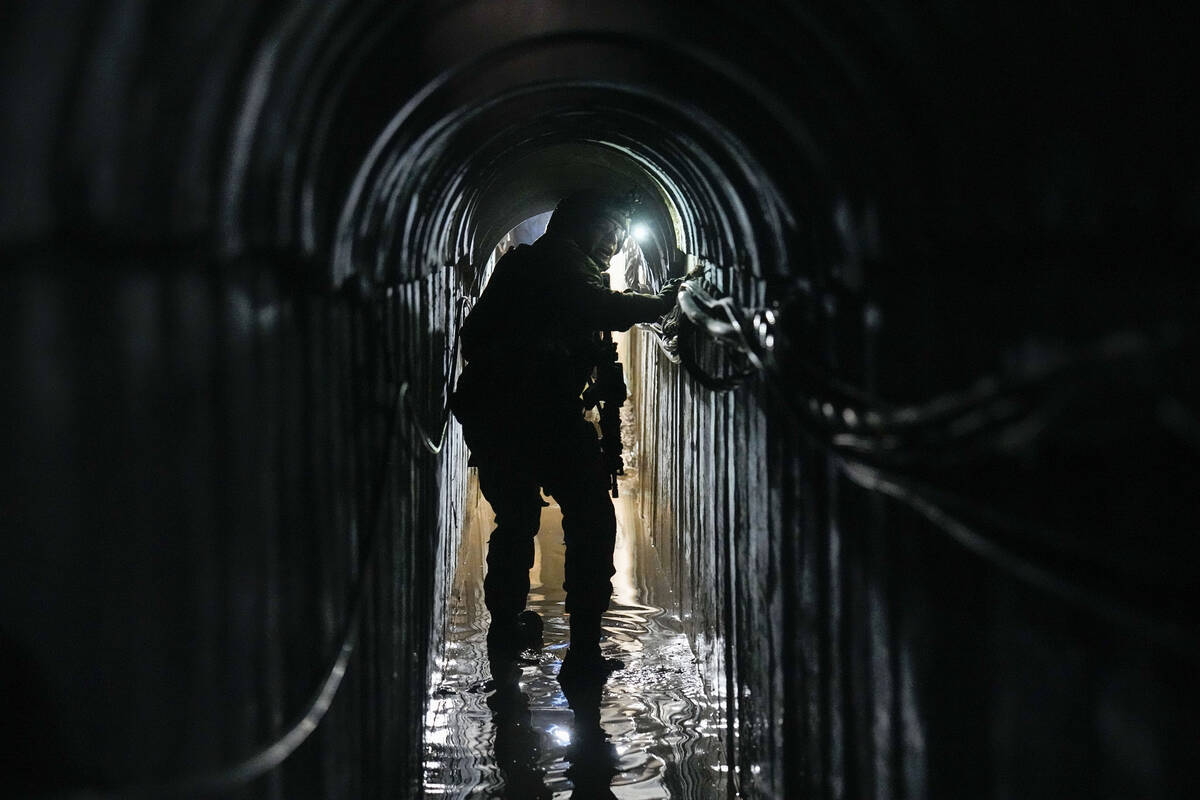Lt. Col. Ido, whose last name was redacted by the military, walks inside a tunnel underneath th ...