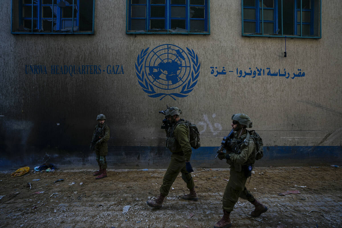 Israeli soldiers take position as they enter the UNRWA headquarter where the military discovere ...