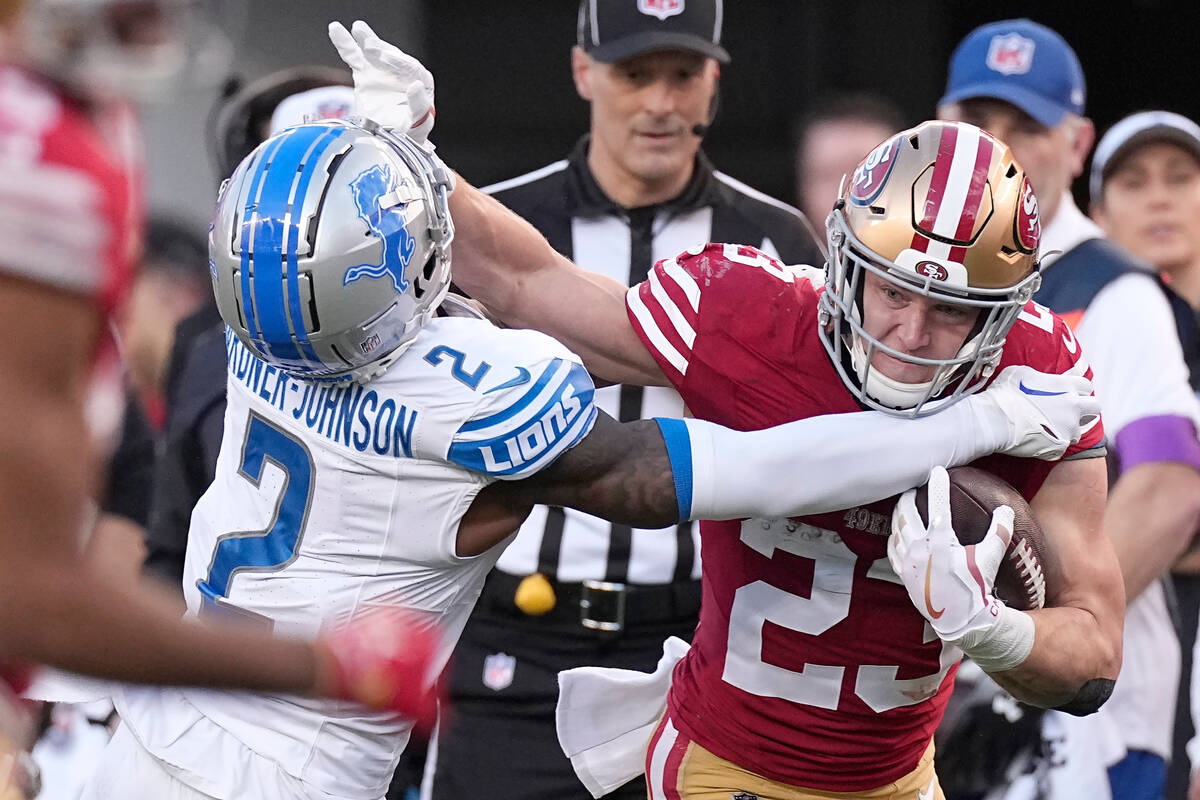 San Francisco 49ers running back Christian McCaffrey (23) runs against Detroit Lions safety C.J ...