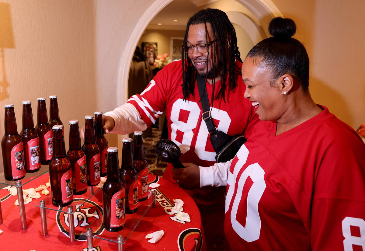 Kevin and Nicole Crockrom of Las Vegas check out bottles featuring photos of them with 49ers pl ...