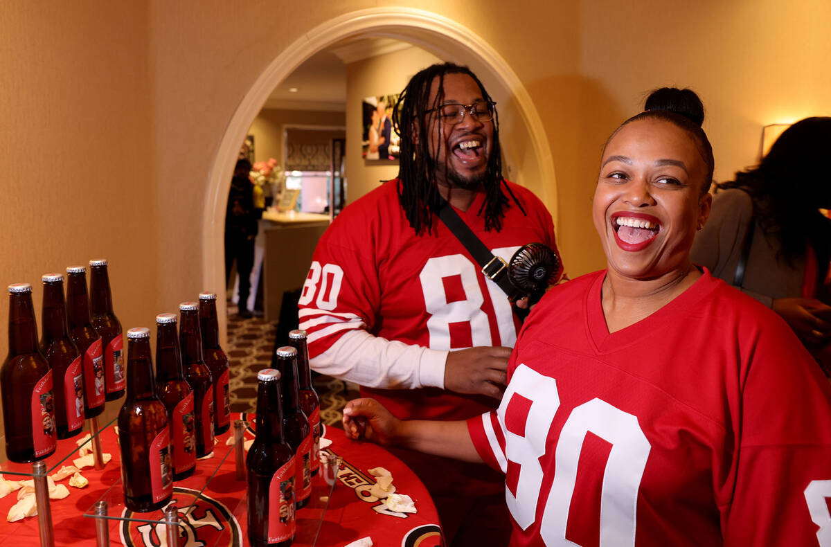 Kevin and Nicole Crockrom of Las Vegas react to bottles featuring photos of them with 49ers pla ...
