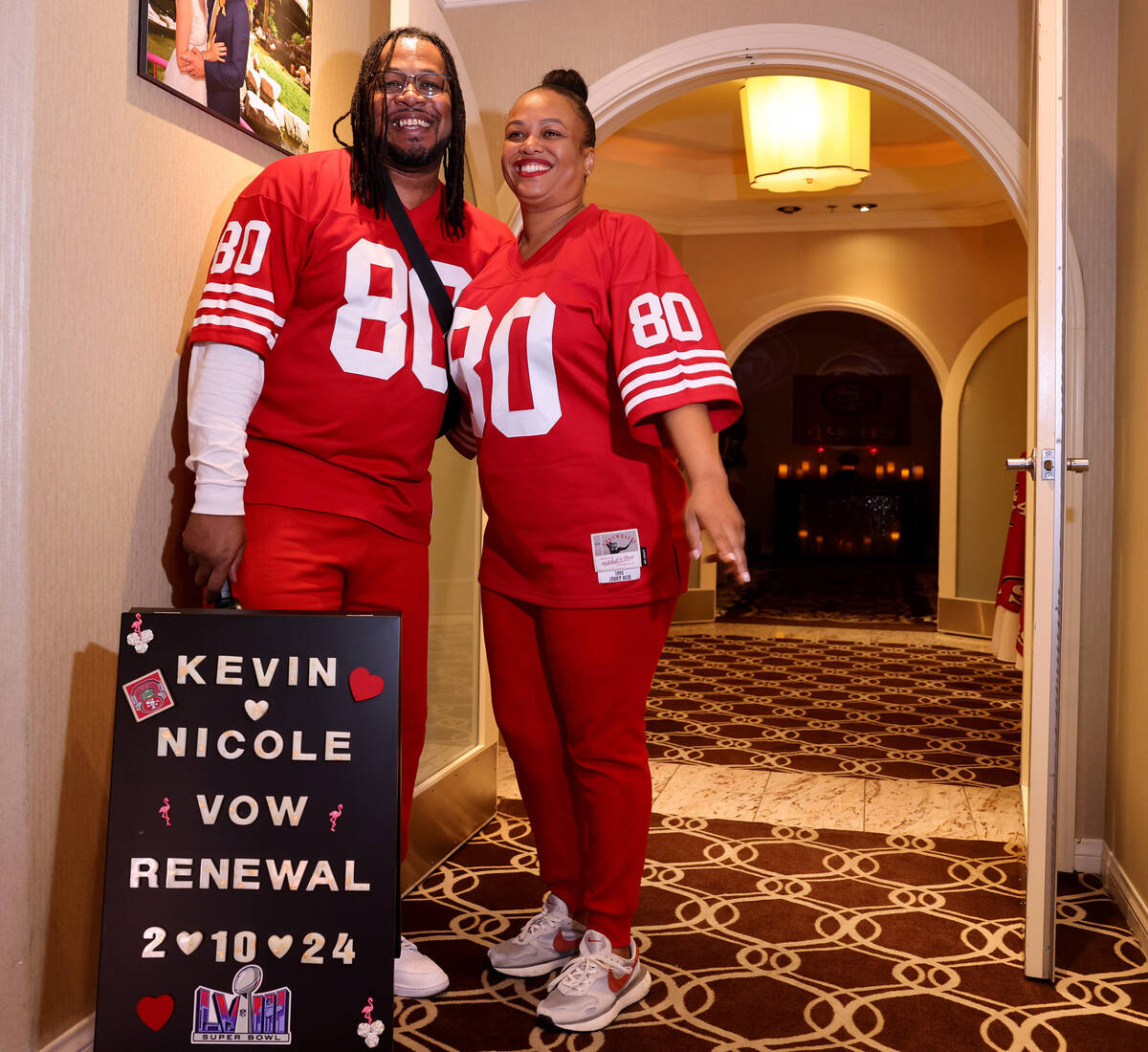 Nicole and Kevin Crockrom of Las Vegas pose with their sign before renewing their wedding vows ...