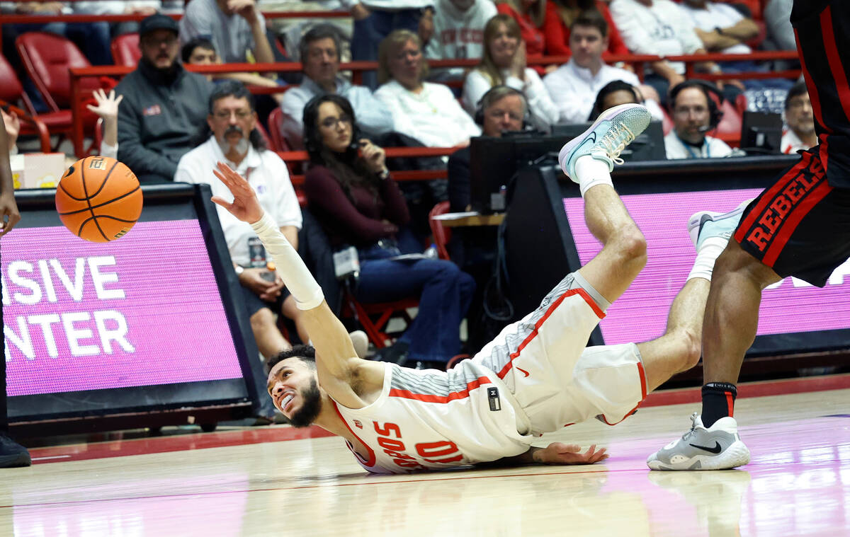New Mexico guard Jaelen House hits the floor while losing control of the ball during the second ...