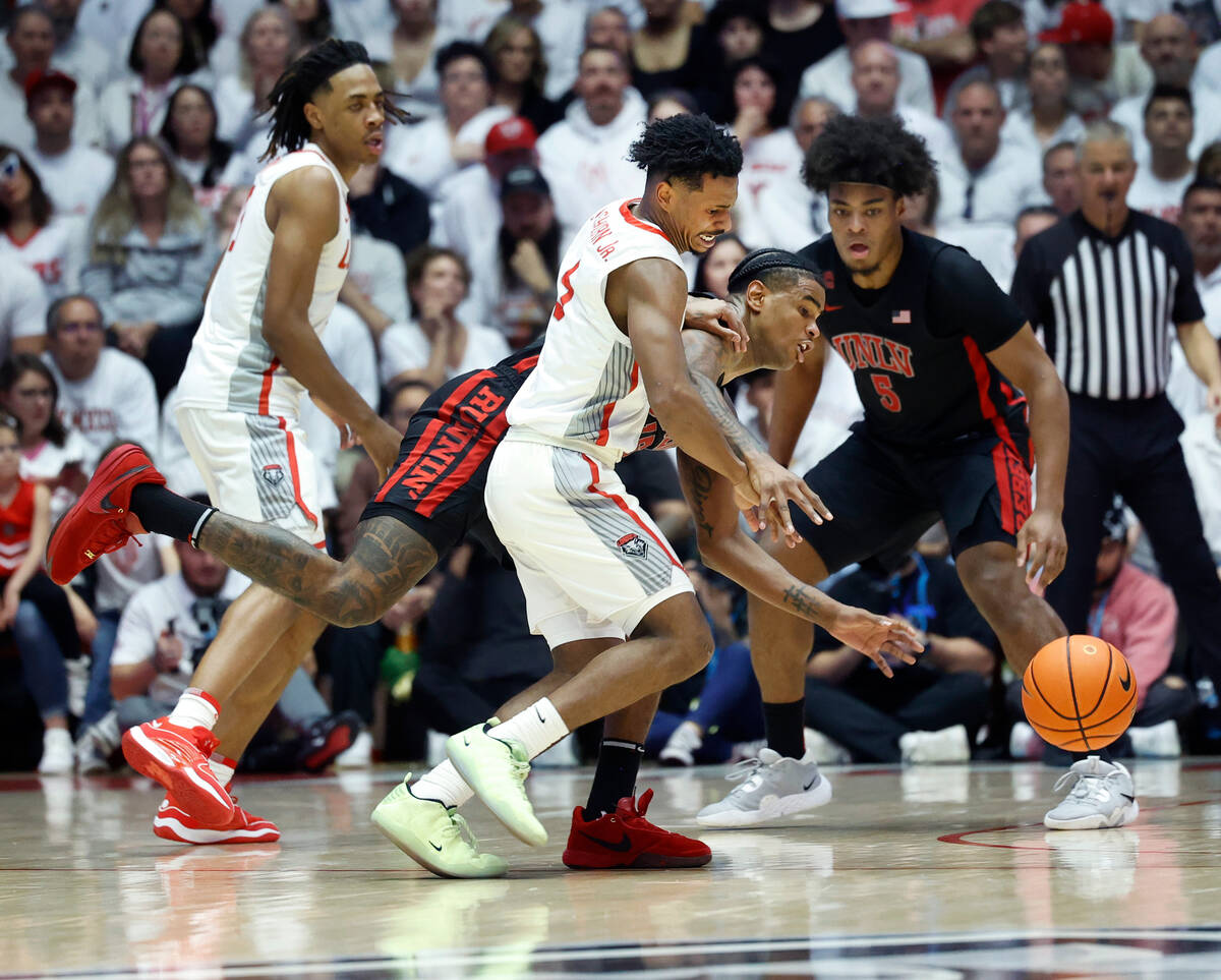 New Mexico guard Jamal Mashburn Jr. loses the ball as UNLV guard Luis Rodriguez defends during ...