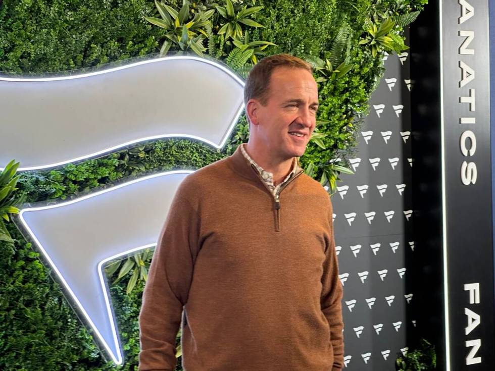 Former NFL player and television personality Peyton Manning walks the blue carpet at the Fanati ...