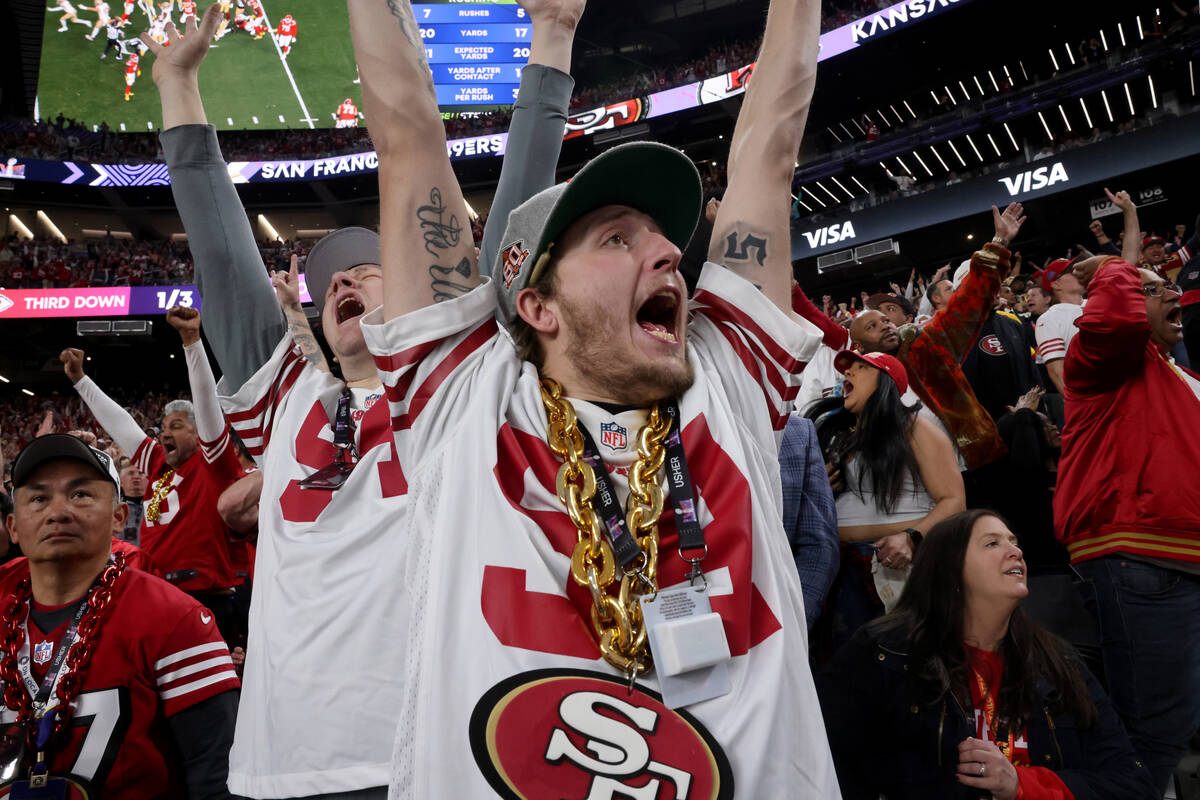 49ers fans Casey Bright, right, and Mike Toland, both of Reno, celebrate as their team holds th ...