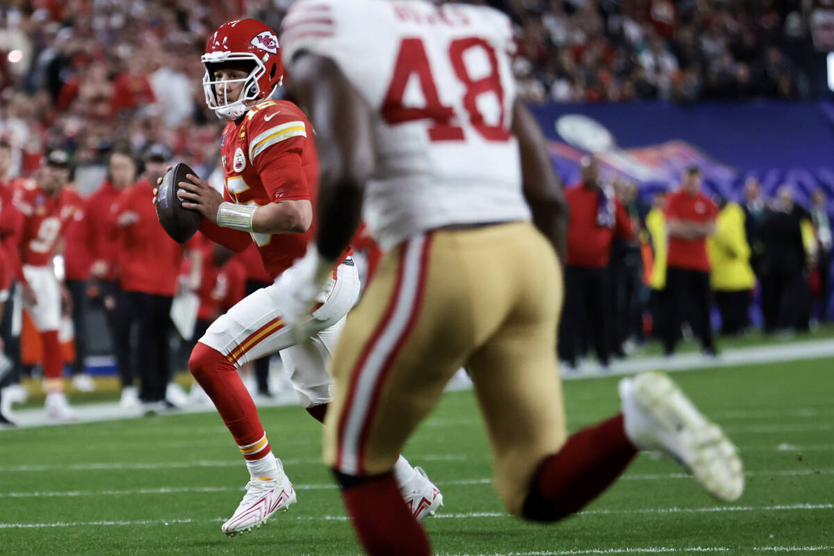 Kansas City Chiefs quarterback Patrick Mahomes (15) rolls out of the pocket during the second h ...