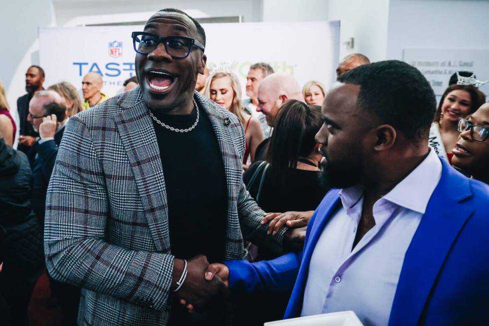 NFL Pro Hall of Famer Shannon Sharpe shakes hands with a fan at the Taste of NFL event at the K ...