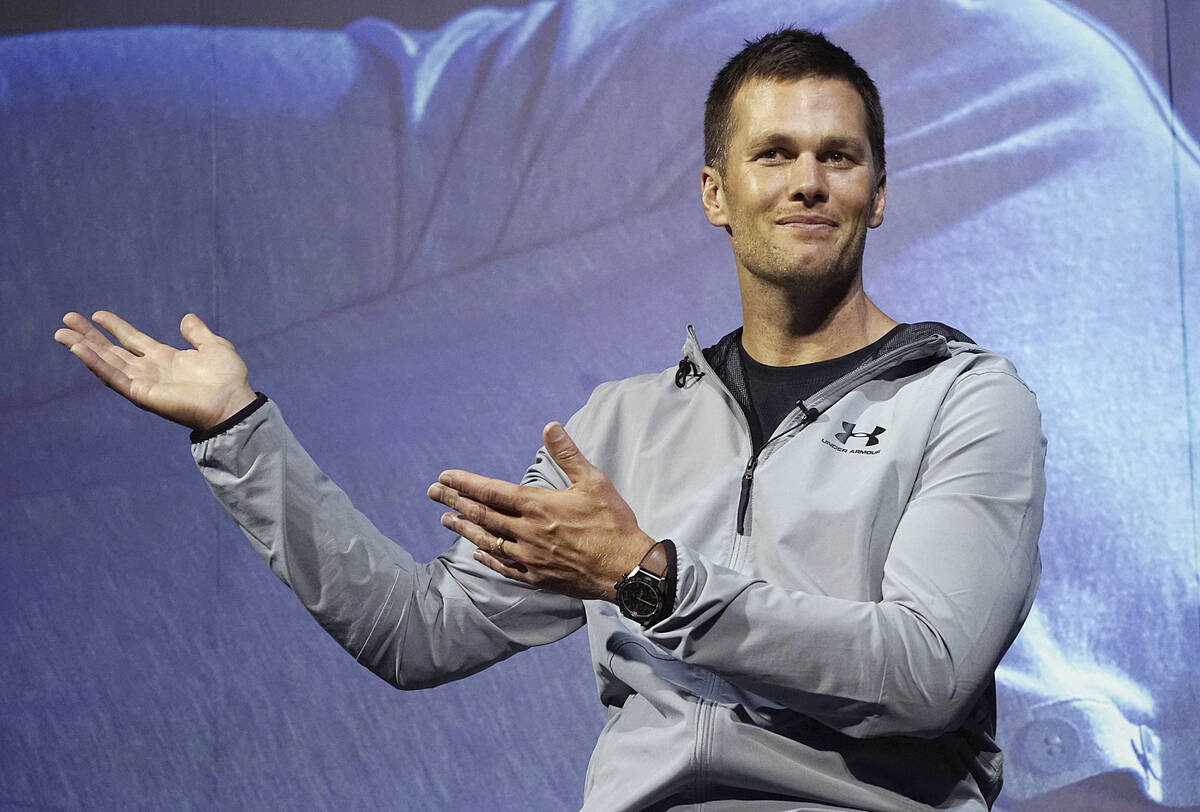 Then-New England Patriots quarterback Tom Brady gestures during a promotional event in Tokyo on ...
