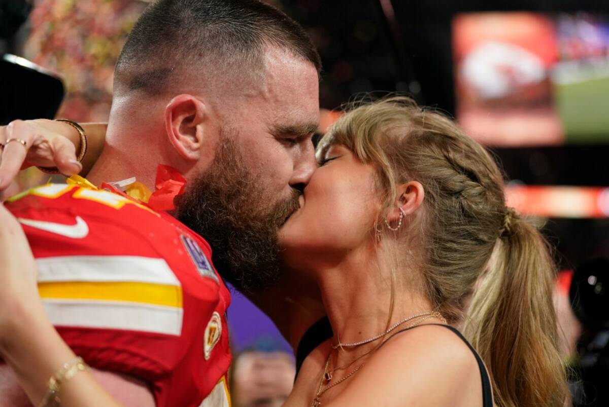 Taylor Swift kisses Kansas City Chiefs tight end Travis Kelce after the NFL Super Bowl 58 footb ...
