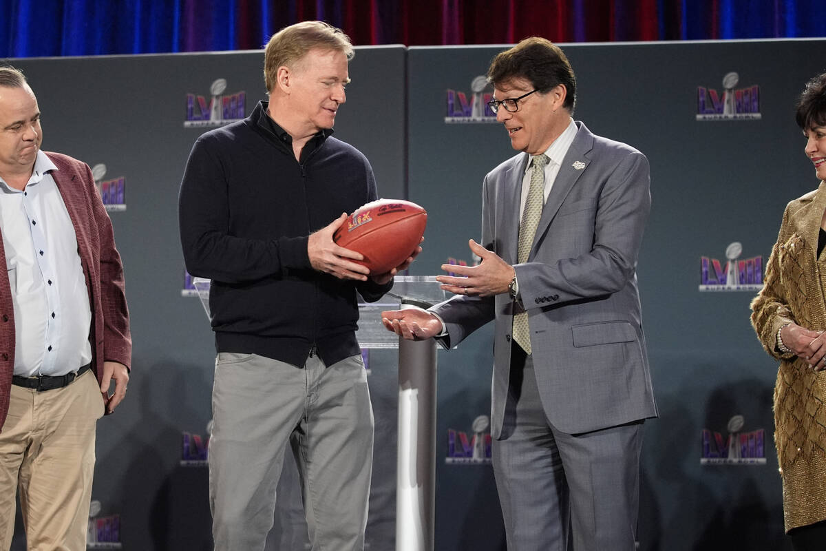 NFL Commissioner Roger Goodell, left, hands off a ball to Jay Cicero, president and CEO of the ...