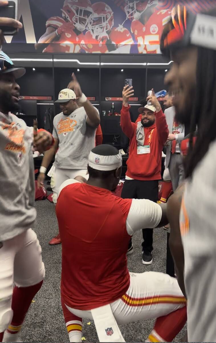 Kansas City Chiefs players dance together in their team's locker room while celebrating their S ...