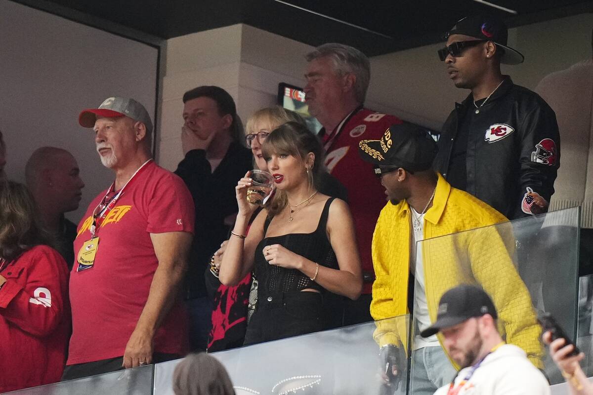 Taylor Swift, center, watches the field before the NFL Super Bowl 58 football game between the ...
