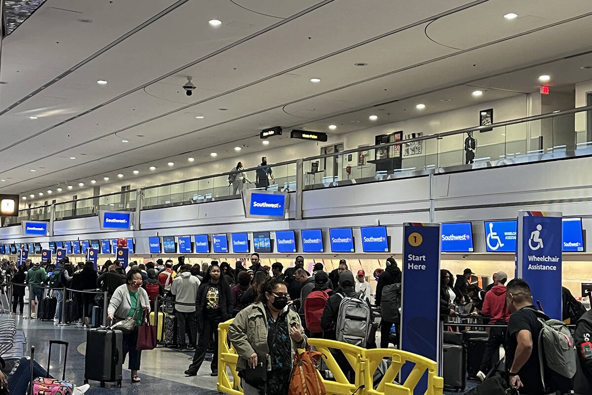 Travelers make their way through Harry Reid International Airport on Monday, Feb. 12, 2024, in ...