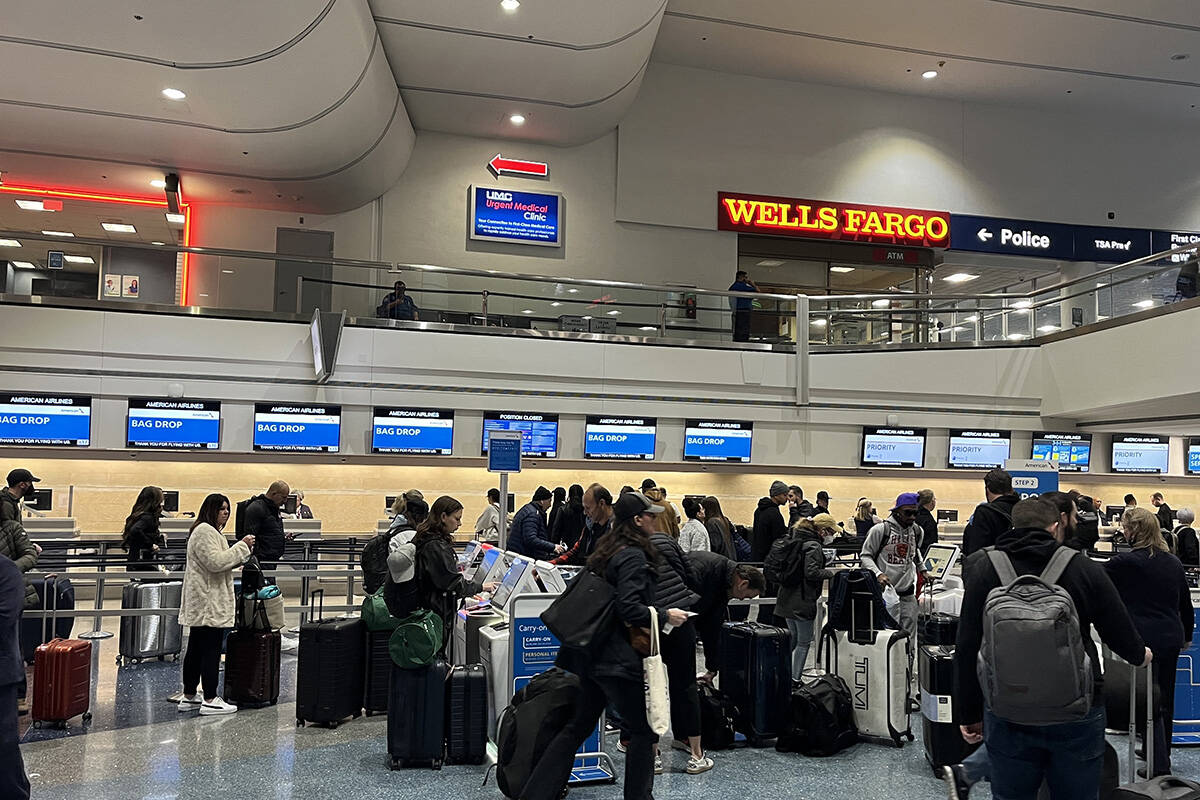 Travelers make their way through Harry Reid International Airport on Monday, Feb. 12, 2024, in ...