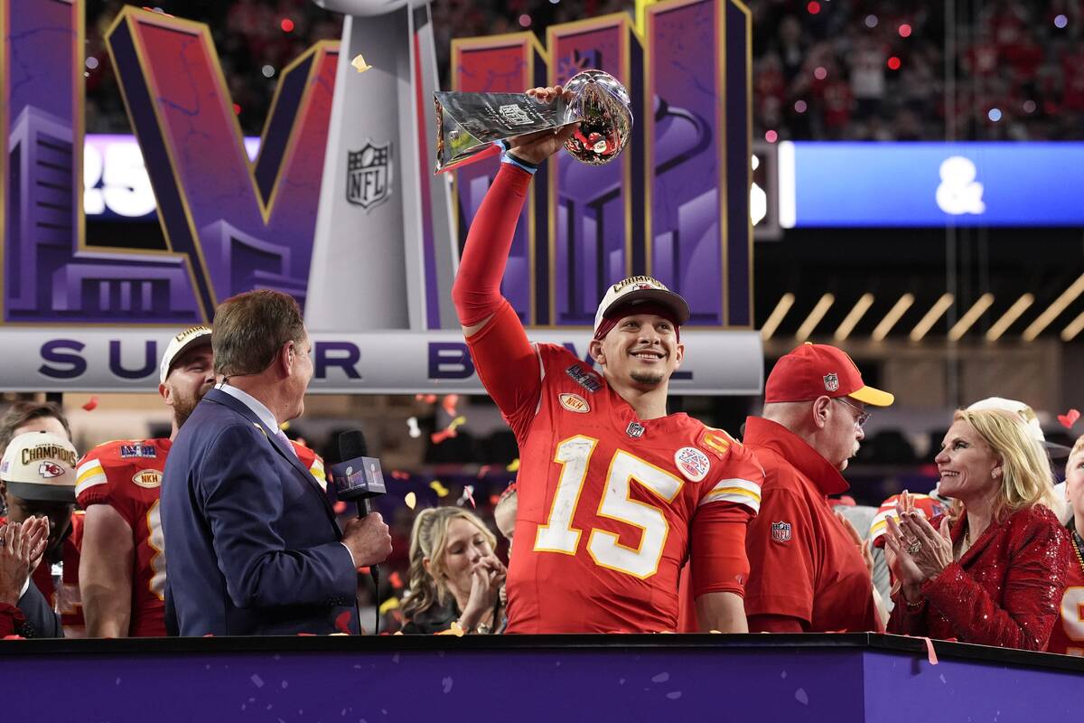 Kansas City Chiefs quarterback Patrick Mahomes (15) holds the Vince Lombardi Trophy after the N ...