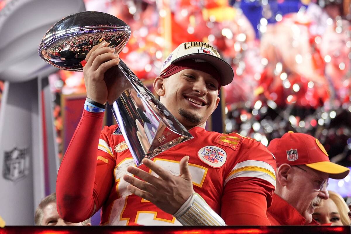 Kansas City Chiefs quarterback Patrick Mahomes celebrates with the trophy after the team's win ...