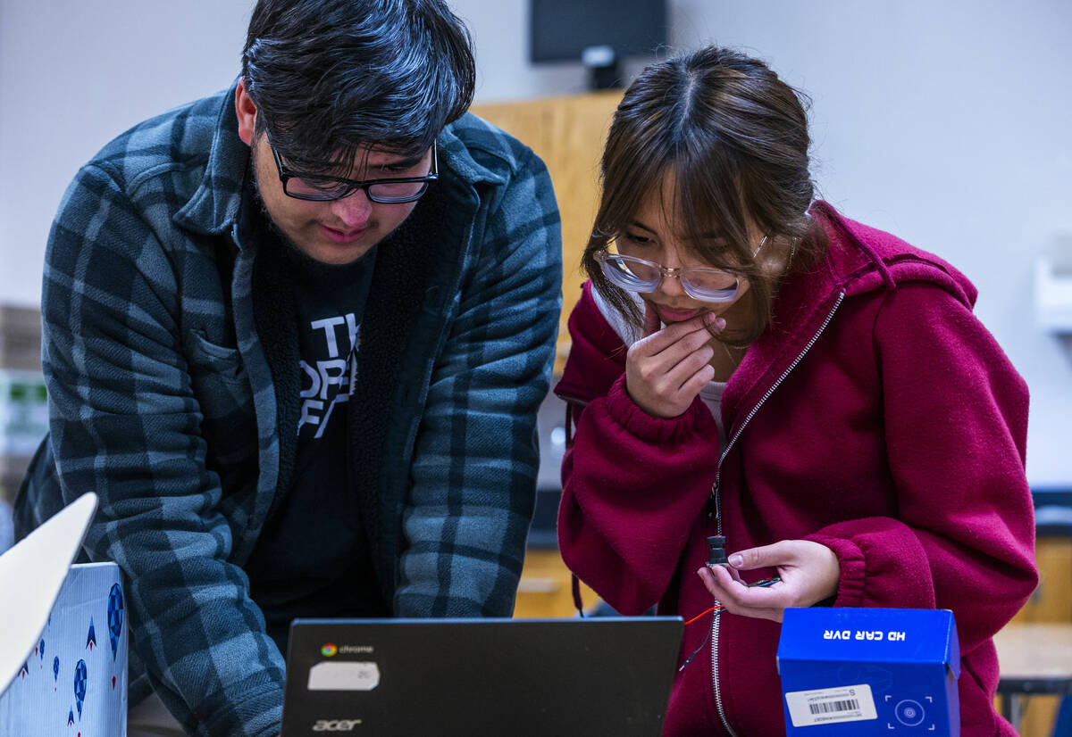 Students Alex Reyes Payan and Stacy Lopez look for electronic components online to purchase as ...