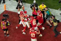 Kansas City Chiefs quarterback Patrick Mahomes, center, celebrates with wide receiver Mecole Ha ...