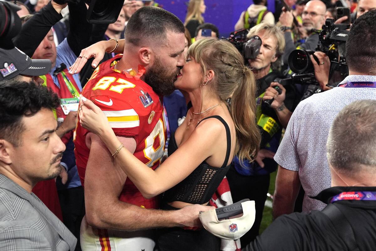 Taylor Swift kisses Kansas City Chiefs tight end Travis Kelce after the NFL Super Bowl 58 footb ...