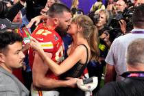 Taylor Swift kisses Kansas City Chiefs tight end Travis Kelce after the NFL Super Bowl 58 footb ...