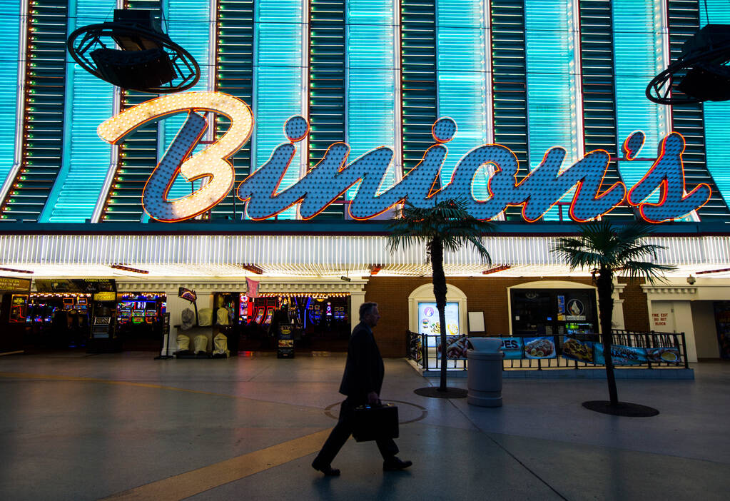 A man walks past Binion's at the Fremont Street Experience in downtown Las Vegas on Tuesday, Ma ...