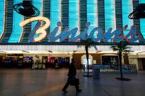 A man walks past Binion's at the Fremont Street Experience in downtown Las Vegas on Tuesday, Ma ...