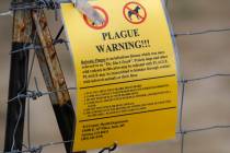 A bubonic plague warning sign is displayed at a parking lot near the Rocky Mountain Arsenal Wil ...