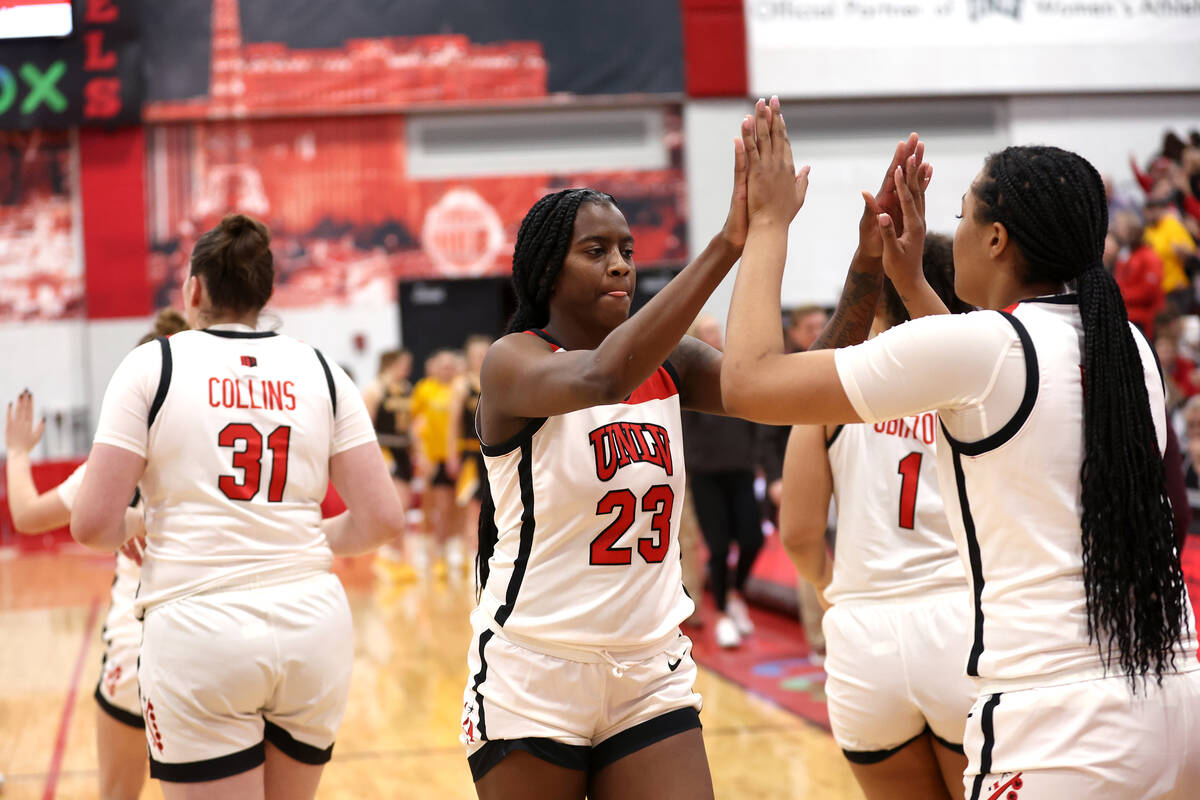 UNLV Lady Rebels center Desi-Rae Young (23) slaps hands with forward Alyssa Brown (44) after th ...