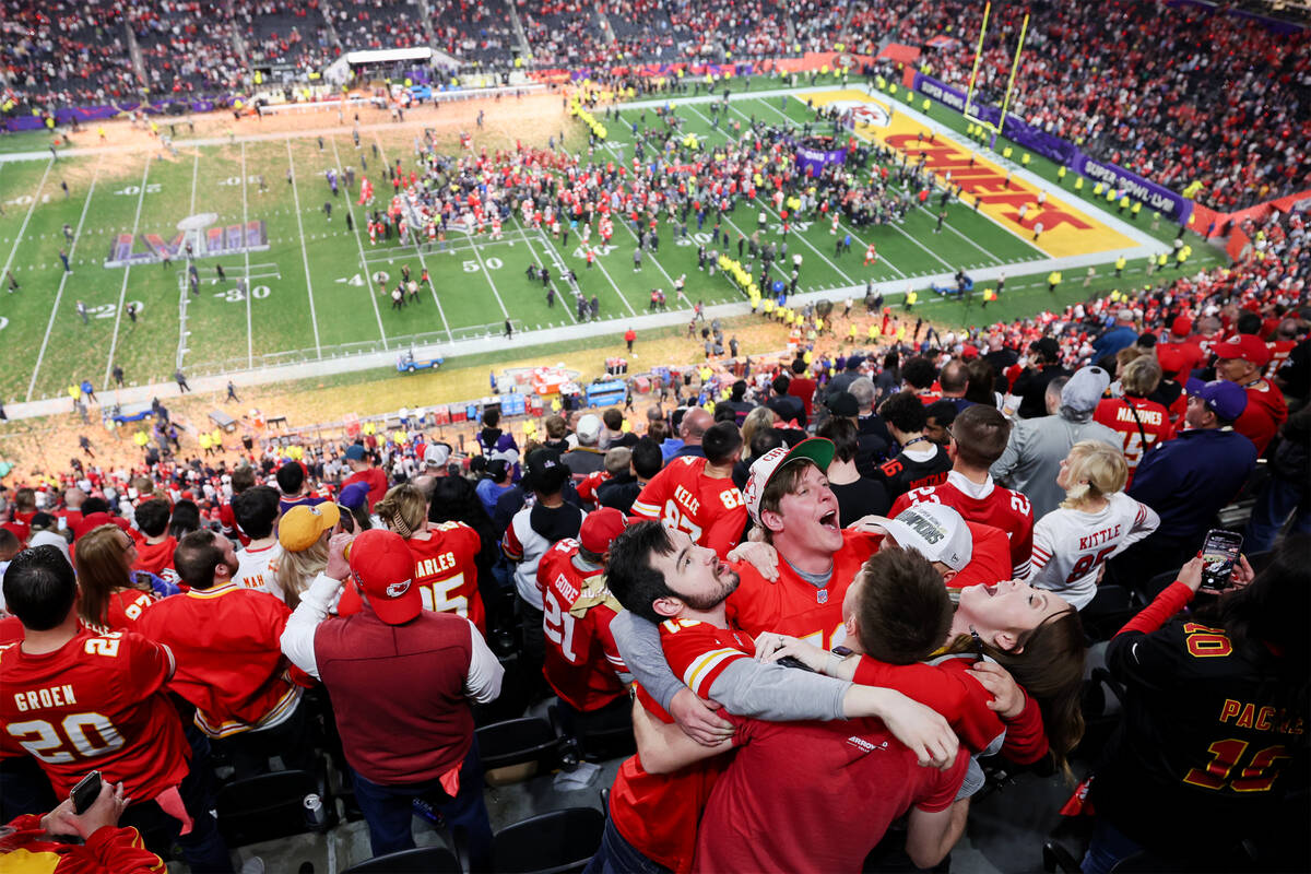A group of Kansas City Chiefs fans embraces after their team won Super Bowl 58 against the San ...