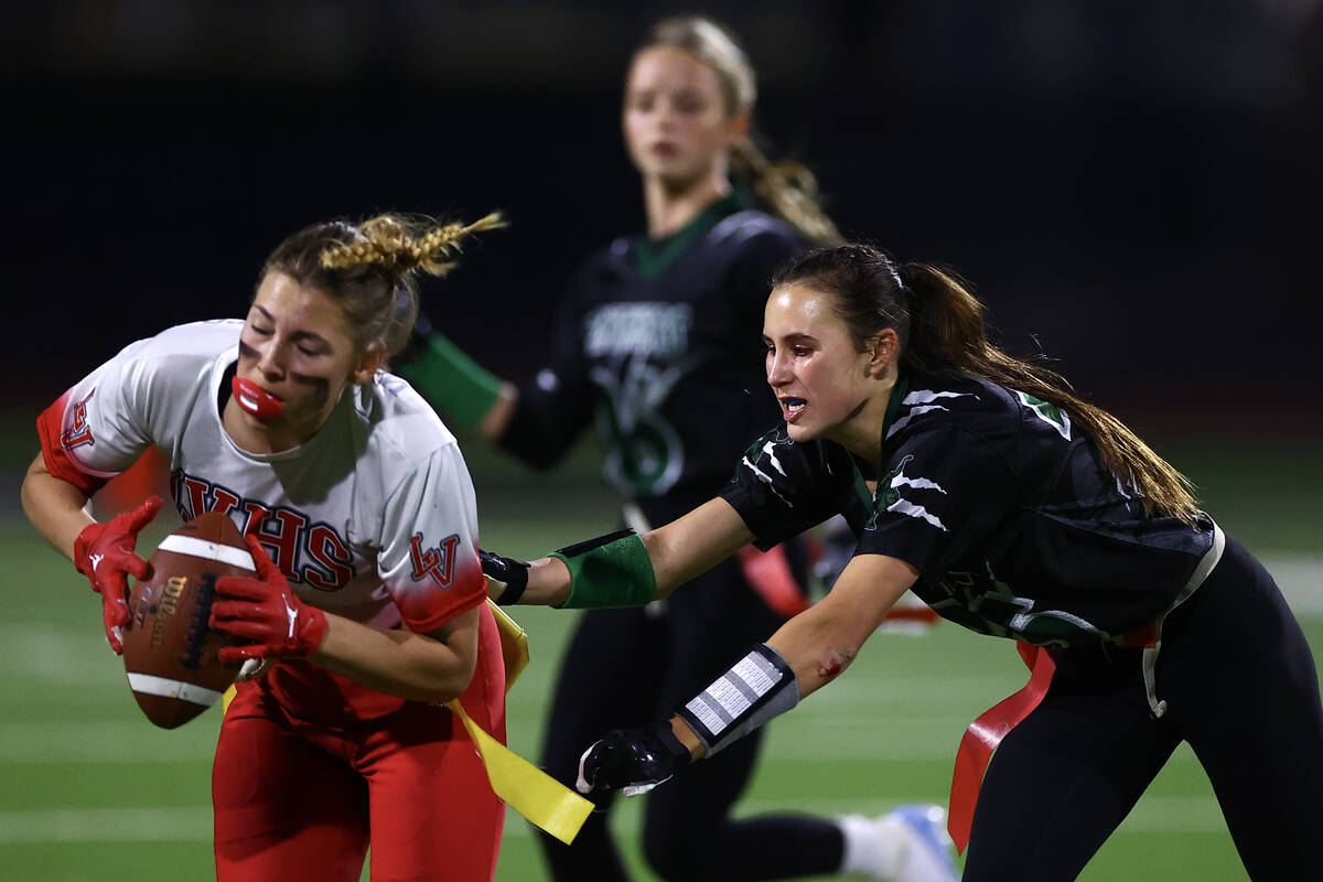 Palo Verde’s Tia Brown (35) takes the flag of Las Vegas’ Sarah Leibowitz (2) duri ...