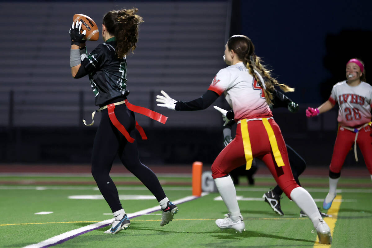 Palo Verde’s Olivia Perkins (25) catches a touchdown pass while Las Vegas’ Emily ...
