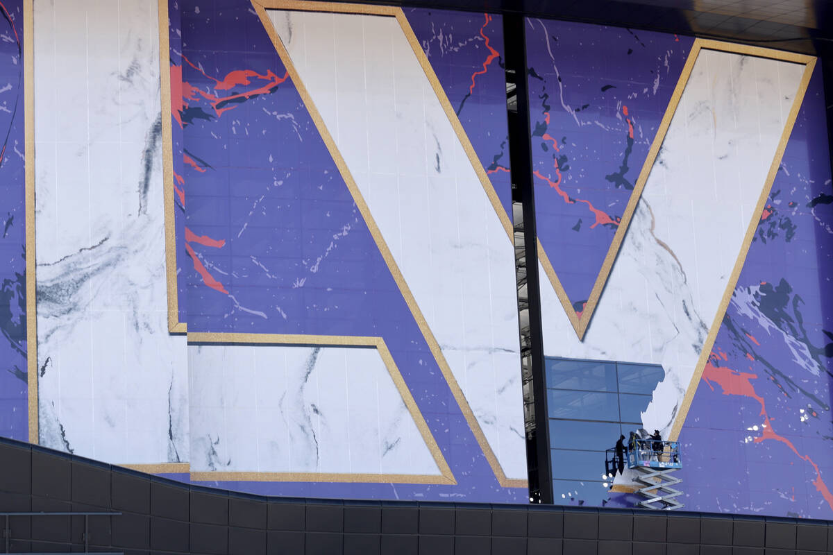 Crews take down graphics from the 2024 Super Bowl at Allegiant Stadium in Las Vegas on Tuesday, ...